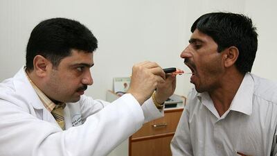 Dr Safdar Reza examines Farid Hussain at Jebel Ali Hospital Corporate Clinic in Dubai.