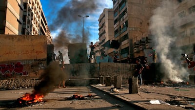 Demonstrators set fires during anti-government protests near Tahrir square, Baghdad, Iraq. AP Photo