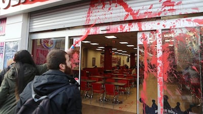 Turkish leftist students throw red ink at a Burger King restaurant in Ankara. A Syrian refugee child has been beaten by a Burger King manager in Istanbul after eating a customer’s leftover fries. Adem Altan / AFP