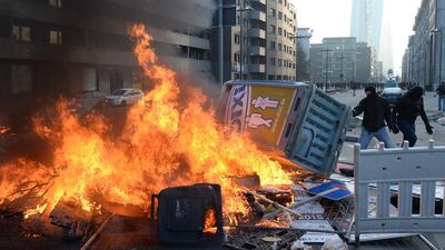 A burning blockade. Police said one officer was injured by stones thrown near the city’s Alte Oper opera house, several private vehicles were burned overnight, and two police cars were set on fire at a police station in the city centre. Boris Roessler / EPA