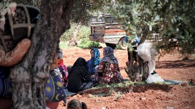 Esraa sitting with a group of women who fled from Latamn.