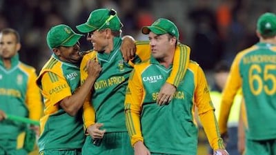 South Africa's Robin Petersen, left, walks off with Johan Botha, center, and AB de Villiers after their win over New Zealand.