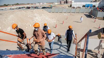 After the Raki thread prayers, worshippers carry bricks to the temple construction site.