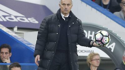 Manchester United manager Jose Mourinho holds the ball during the English Premier League match against Chelsea at Stamford Bridge in London, Sunday, October 23, 2016. Kirsty Wigglesworth / AP Photo