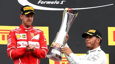 Mercedes' Lewis Hamilton celebrates with the trophy after victory in the 2017 Belgian Grand Prix alongside second-placed Ferrari driver Sebastian Vettel. Francois Lenoir / Reuters