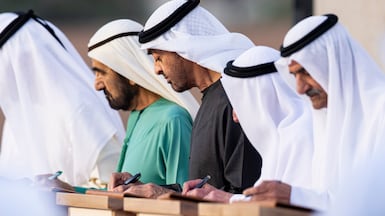 President Sheikh Mohamed, centre, and Sheikh Mohamed bin Rashid, Vice President and Ruler of Dubai, Sheikh Dr Sultan bin Muhammad Al Qasimi, Ruler of Sharjah, and Sheikh Hamad bin Mohammed Al Sharqi, Ruler of Fujairah, sign a document at the launch of the National Education Charter. Ryan Carter / UAE Presidential Court