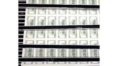 Sheets of one hundred dollar bills are fed through a sorting machine at the Bureau of Engraving and Printing in Washington, D.C., U.S., on Wednesday, Oct. 14, 2009. Goldman Sachs Group Inc. said the dollar is likely to extend drops against the euro and commodity backed currencies over the coming six months, based on the greenback's correlation with cyclical assets and capital flows. Photographer: Andrew Harrer/Bloomberg *** Local Caption *** 581656.jpg