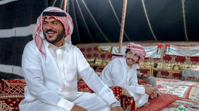 Abu Dhabi, United Arab Emirates, December 10, 2019. -- Fahd Al Dossari, left, from Saudi Arabia relaxes after a victory at the Al Dhafra Festival in Abu Dhabi, UAE. Victor Besa / The National Section: NA Reporter: Anna Zacharias