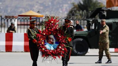 Afghan soldiers carrying a wreath for Abdul Jabbar Qaharmaan, a prominent Afghan politician and candidate of the upcoming Parliamentary elections, who was killed in a bomb attack in Helmand. Jawad Jalali / EPA