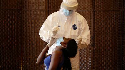 A health worker tests a migrant domestic worker from Africa for the coronavirus disease (COVID-19) at a hotel, before she travels back to her country, in Beirut suburbs, Lebanon. REUTERS