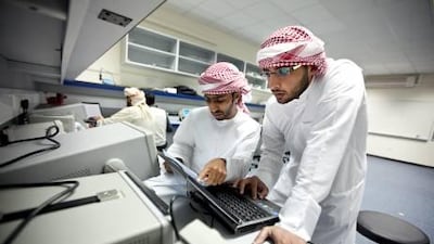Ali Al Braiki, left, and Abdul Aziz Al Muhairi, right, work during their mechatronics class at the Ruwais campus of the Higher Colleges of Technology.