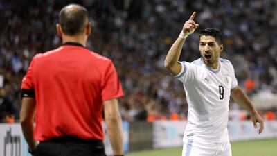 Uruguay's forward Luis Suarez gestures at the referee. AFP