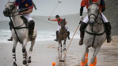 Polo players Andy Burgess (R) riding Tonka Rob Brockett riding Torda (L) and Ben Marshall (C) riding Shriva practice for the beach polo competition being held on the beach at Watergate Bay, near Newquay. Matt Cardy / Getty Images