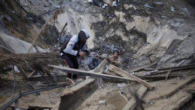 Palestinians inspect a site which witnesses said was hit in an Israeli air strike, in Khan Younis in the southern Gaza Strip. Ibraheem Abu Mustafa / Reuters