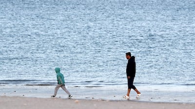 Visitors enjoying the cold weather at the Khor Fakkan beach in Sharjah. Pawan Singh / The National