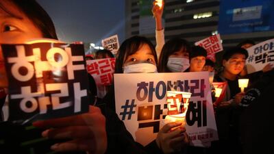 South Koreans hold placards and candles as they march in a protest against president Park Geun-hye in Seoul on November 5, 2016. Jeon Heon-kyun / EPA