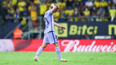 Frenkie de Jong walks off the pitch after being shown a red card. Getty Images