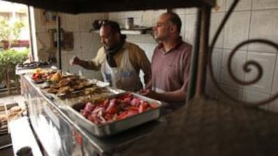 Mohammed Khalaf, right, at Abu Hamdy Cafeteria: business is up as protesters gather at the nearby People's Council to protest.