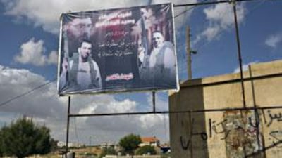 A poster salutes the dead Baalbek fighters, including the suspected drug baron Ali Abbas Jaafar, left, in the Hay al Sharawneh neighbourhood of Baalbek near a Lebanese army checkpoint.