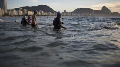 In this July 14, 2015 photo, beachgoers wade into the waters of Copacabana Beach in Rio de Janeiro, Brazil. An Associated Press analysis of water quality found not one water venue safe for swimming or boating in Rio's waters. Over 10,000 athletes from 205 countries are expected to compete in next year's Summer Olympics. Hundreds of them will be sailing in the waters near Marina da Gloria in Guanabara Bay; swimming off Copacabana Beach; and canoeing and rowing on the brackish waters of the Rodrigo de Freitas Lake. Leo Correa / AP Photo
