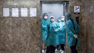 Journalists wear protective suits inside an elevator as they prepare for a media visit to Indonesian Health Ministry's Laboratorium for Research on Infectious-Diseases, following the outbreak of the new coronavirus in China, in Jakarta, Indonesia. Reuters
