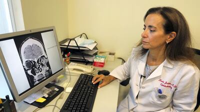 Lebanese doctor Nada Jabbour displays the image of a patient's skull who was hit in the eye with a projectile fired by security forces during an anti-government protest, on August 16, 2020 in Beirut. AFP