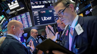 Traders work near the post where Uber is traded on the floor at the New York Stock Exchange. Shares in the ride-hailing giant have slumped in the first couple days of trading. Reuters