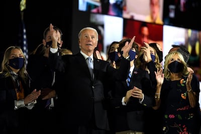US President-elect Joe Biden with his wife Jill Biden, salute the crowd on stage after being declared the winner of the US presidential election. AFP