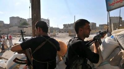 Syrian rebels man a checkpoint in the northern city of Aleppo. "Aleppo is the capital of the north and the northern regions are already in their hands so, if this city falls, the regime is over and the two sides know it," an activist says.