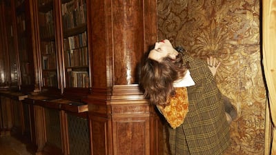 Alexa Chung poses inside the Aman Venice Hotel wearing a tweed Prada cape, available from July 15 online at Mytheresa.com. Courtesy of Mytheresa.com