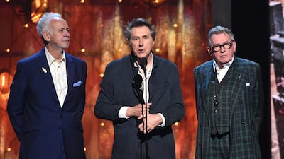 Inductees Phil Manzanera, from left, Bryan Ferry and Andy Mackay, of Roxy Music, accept a trophy. AP