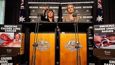 Australian Attorney General Nicola Roxon left, and the Tanya Plibersek, the health minister, speak after Australia’s highest court ruled it was legal for the government to make tobacco companies package cigarettes without prominent branding.