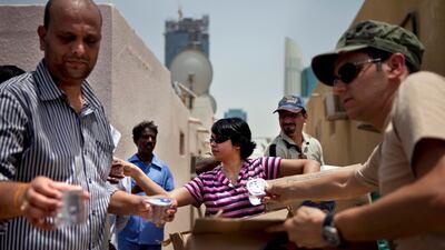 Volunteers distribute water to labourers living in the Satwa neighborhood of Dubai. Silvia Razgova / The National