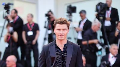 Oliver Cheshire wears an open-collar black Armani tuxedo. Getty Images