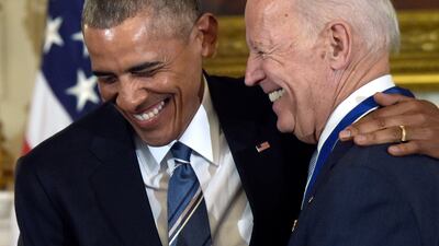 Former US president Barack Obama laughs with Mr Biden, who was vice president at the time, during the ceremony in which Mr Obama presented Mr Biden with the Presidential Medal of Freedom on January 12, 2017. AP