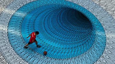 Andrew Clark plays basketball in the atrium of the Woodward's building on a mural placed on the ground to mark World Sight Day in Vancouver, British Columbia. Darryl Dyck / The Canadian Press via AP