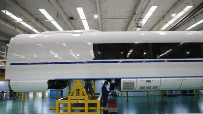 An employee works on a final assembly line for CRH380B, a high speed train model. Kim Kyung-Hoon / Reuters