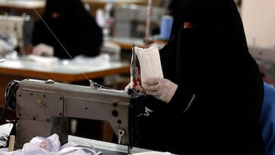 A Yemeni woman works to manufacture protective face masks at a workshop in Sanaa, Yemen. EPA