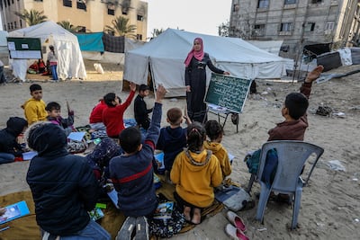 Pupils have lessons near tents and makeshift shelters in Khan Younis. Getty Images
