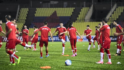 Members of Syria's national football team warm up during a training session in Malacca, Malaysia, on October 4. Nazrulhad Hashim / AFP