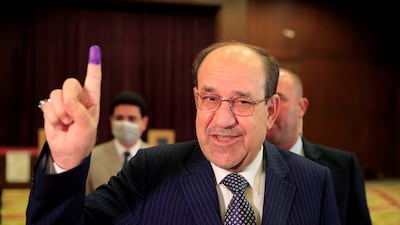 Former Iraqi prime minister Nouri Al Maliki shows his inked finger at a polling station in Baghdad, after voting in 2021. He is again in the running for the PM's role. Reuters