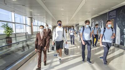 Sakhir Grand Prix winner Sergio Perez is accompanied by Etihad Airways staff at Abu Dhabi Airport.