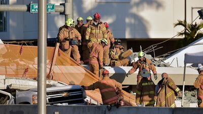 A new pedestrian bridge over a major road in Miami collapsed, killing four people and trapping multiple cars below. Michael Laughlin / South Florida Sun-Sentinel via AP
