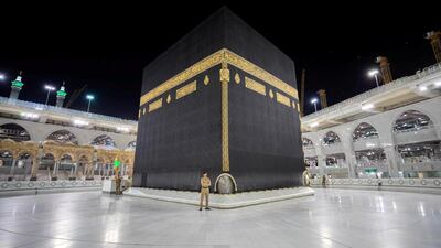 Saudi security officers stand in front of the Kaaba at an empty Grand mosque in Makkah, Saudi Arabia. Reuters