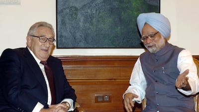 Mr Singh with former US secretary of state Henry Kissinger in New Delhi, in 2004. AFP