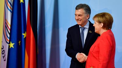 German Chancellor Angela Merkel welcomes Argentinia's president Mauricio Macri. Tobias Schwarz / AFP Photo