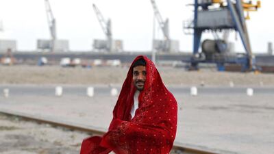 A worker wraps himself with a cloth after his shift was over at Mundra Port. Amit Dave / Reuters