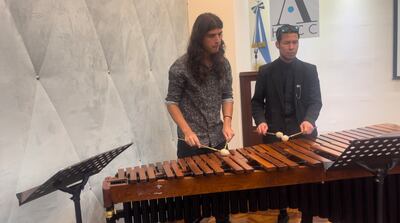 Students Franco Pereira and Jose Mendoza perform the Qatari national anthem on the marimba in Buenos Aires. Aveen Karim / The National
