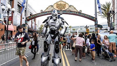 A fan in a huge robot costume towers over sightseers in the Gaslamp District on first day of the 2015 Comic-Con International. Denis Poroy / Invision / AP