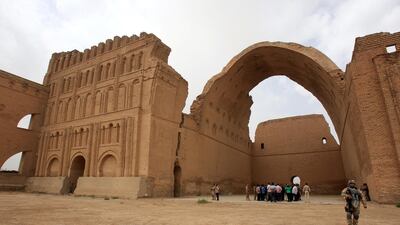 Iraqis stand under the arch of the barrel-vaulted hall of the Ctesiphon palace, which was in the imperial capital of the Persian Empire in the Parthian and Sassanian times, near Madean, 30 kilometres south of Baghdad. AFP